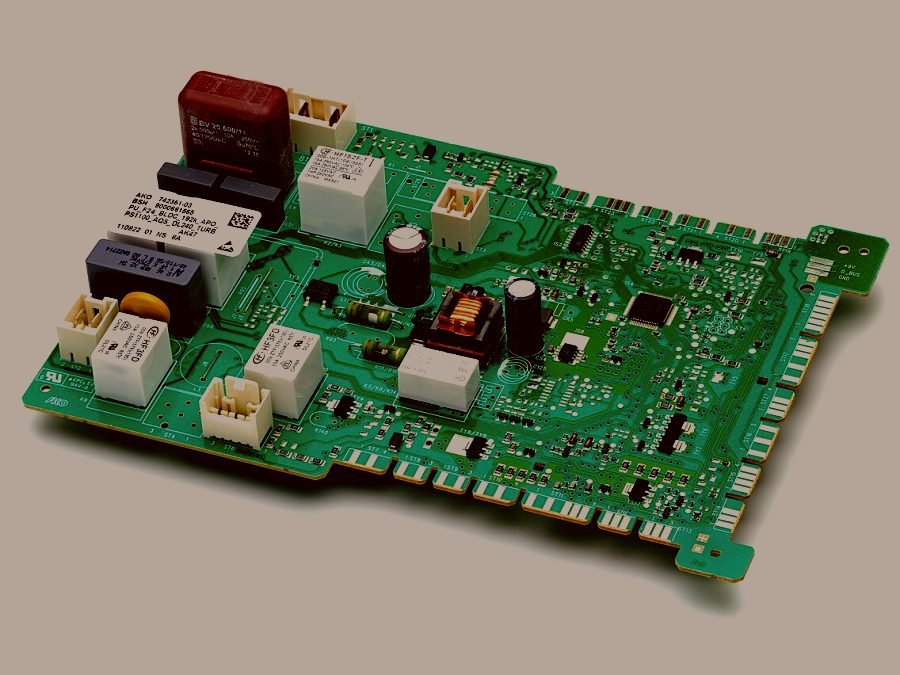 A washing machine power module with its relays and connectors exposed