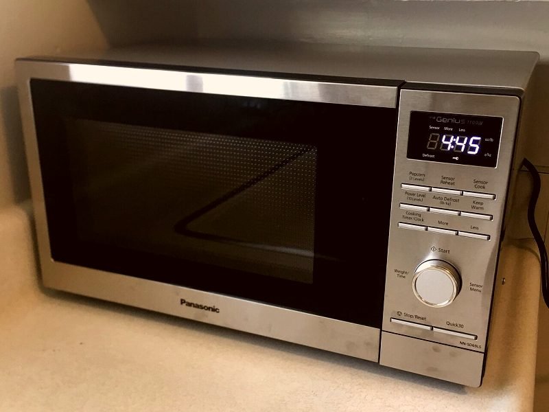 A stainless steel microwave oven on a kitchen counter